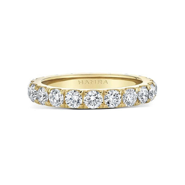 Custom made eternity band featuring 2.10 carats total weight in round brilliant cut diamonds set in 18k yellow gold.