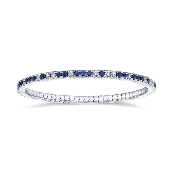 Hand crafted eternity bracelet featuring 2.60 carats total weight in round blue sapphires and 1.10 carats total in round brilliant cut diamonds set in 18k white gold.