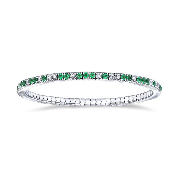 Custom made eternity bracelet featuring 2.02 carats total weight in emeralds and 1.12 carats total in round brilliant cut diamonds set in 18k white gold.