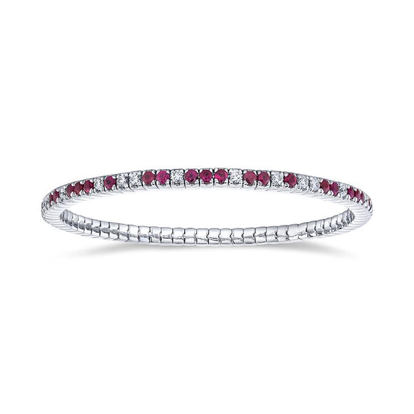 Custom made eternity bracelet featuring 2.38 carats total weight in rubies and 1.10 carats total in round brilliant cut diamonds set in 18k white gold.