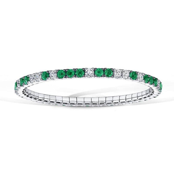 Custom made eternity bracelet featuring 5.15 carats total weight in emeralds and 3.45 carats total in round brilliant cut diamonds set in 18k white gold.