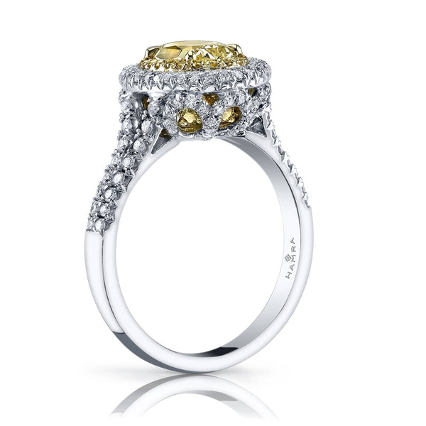 Custom made ring featuring a 1.24 carat oval shaped fancy yellow diamond center stone with .60 carats total weight in round brilliant cut diamonds, .18 carats total in round fancy yellow accent diamonds set in platinum and 18k yellow gold.