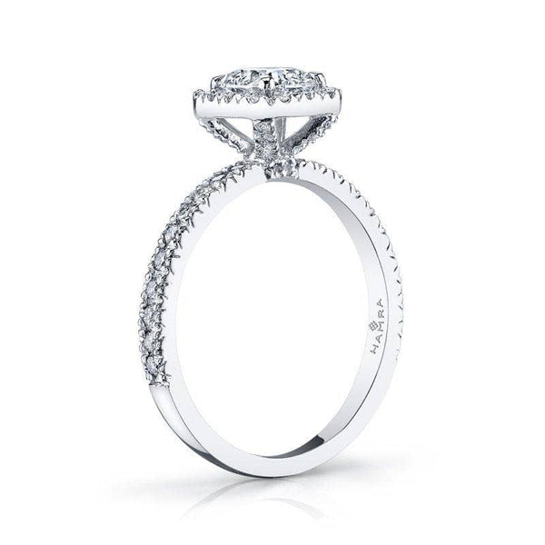 Custom made ring featuring a .77 carat cushion cut center diamond with .39 carats total weight in round brilliant cut accent diamonds set in platinum.