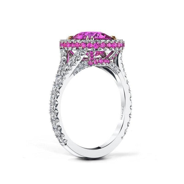 Lovely ring featuring a vivid 3.25 ct. cushion cut pink sapphire with .72 carats total weight in diamonds and .48 carats total in pink sapphire accents set in platinum.