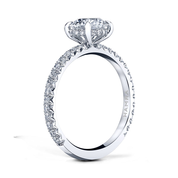 Custom made ring featuring a 1.25 carat round brilliant cut diamond center with .43 carats in round brilliant cut accent diamonds set in platinum.