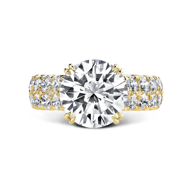 Custom manufactured ring featuring a 4.00 carat round brilliant cut diamond center surrounded by an additional 1.60 carats total weight in accent round diamonds set in 18k yellow gold.